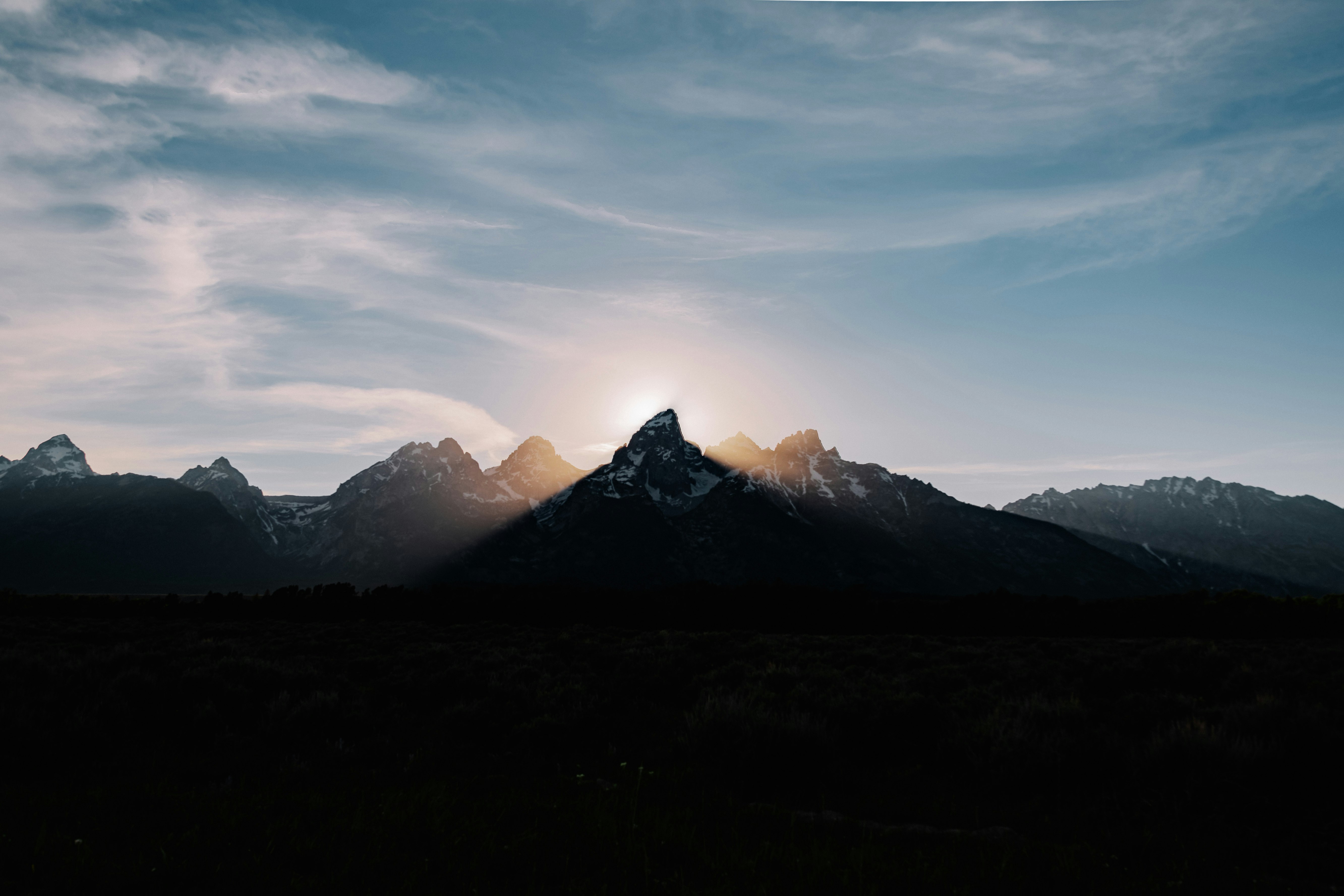 silhouette of mountains under blue sky during daytime